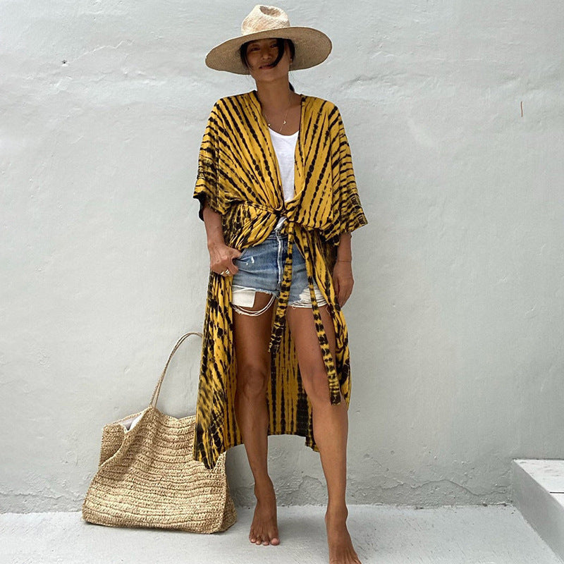 Yellow-and-black patterned cover-up tied loosely at the front.