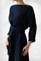 Dark blue dress with a wide neckline and wrapped waist ties.
