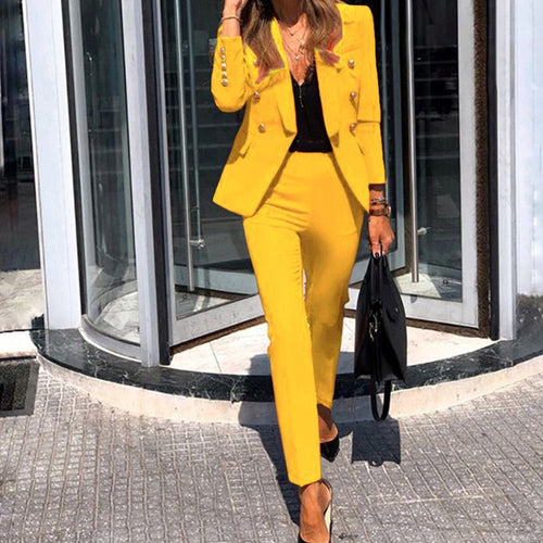 Yellow Abigail blazer and slim-leg trouser set worn outdoors.