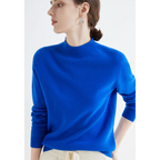 Royal-blue jumper worn with light trousers.