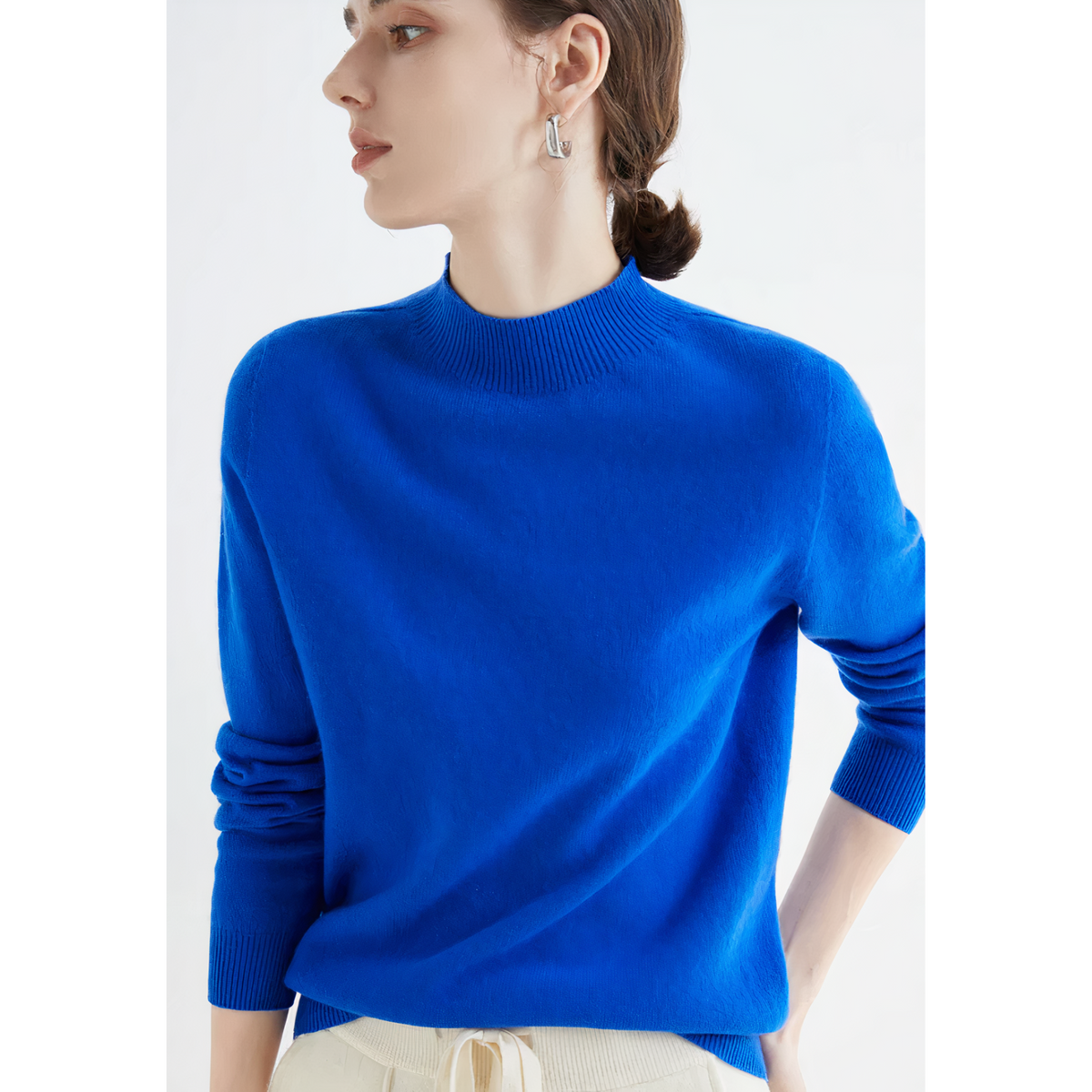 Royal-blue jumper worn with light trousers.