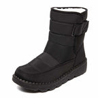 Black winter boot with a light lining and broad upper strap.