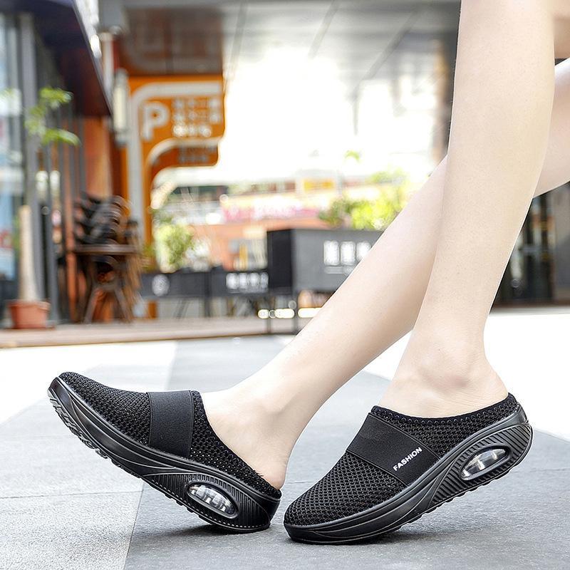 Black open-back shoes shown from the side and front.