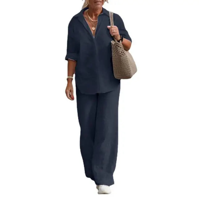 Navy collared shirt and matching trousers with loose legs.