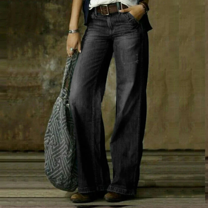Grey full-length trousers with wide legs and belt loops.