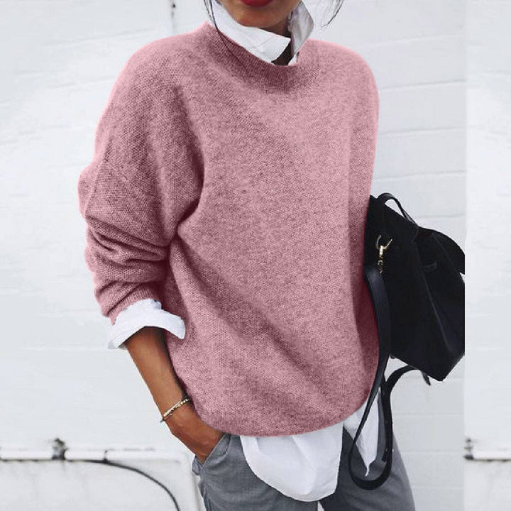 Pink soft-textured jumper worn over a white shirt.