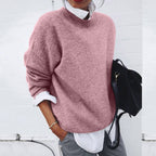 Pink soft-textured jumper worn over a white shirt.