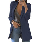 Navy blue long open-front blazer worn with jeans.