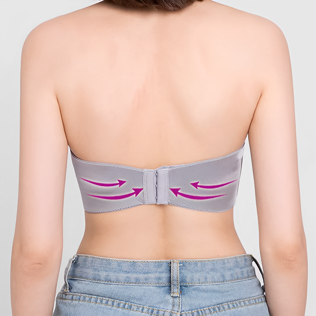 Rear view of a grey strapless bra with a back fastening and arrows.