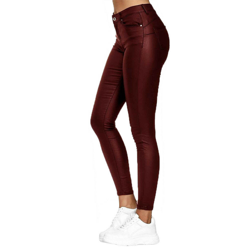 Side view of burgundy skinny jeggings and their fitted legs.