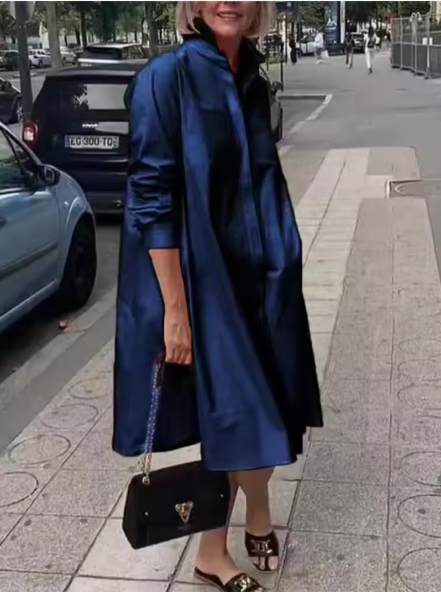 Blue loose shirt dress worn outdoors, with the sleeves pushed up.