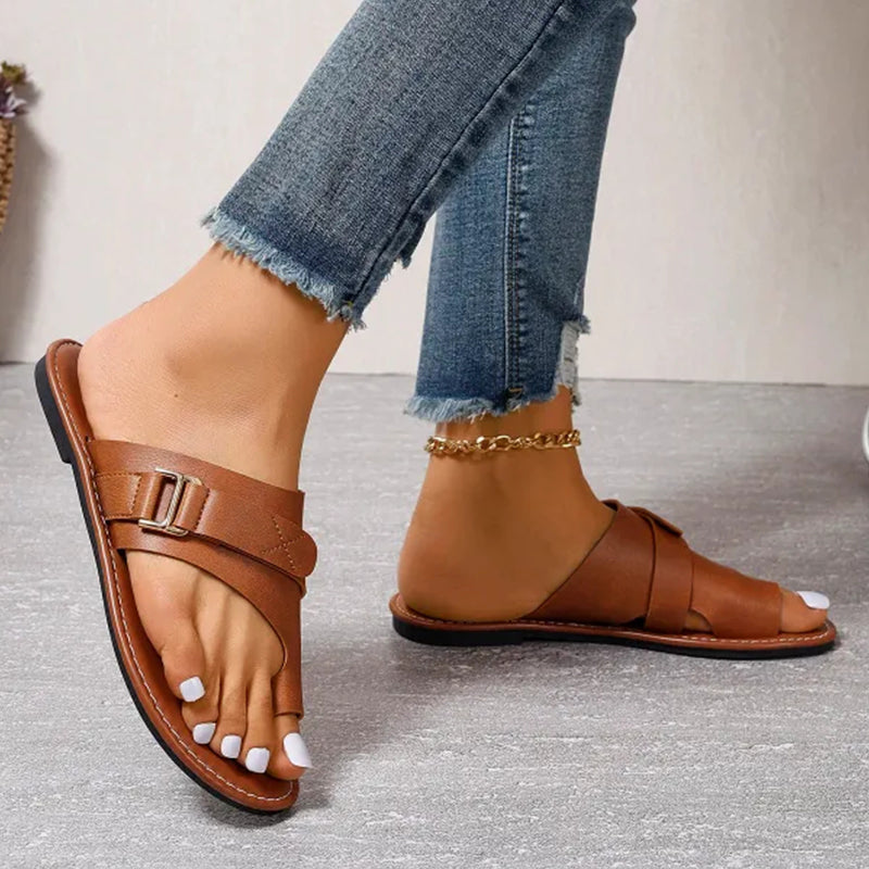 Brown sandals showing a toe loop, side buckle and low sole.