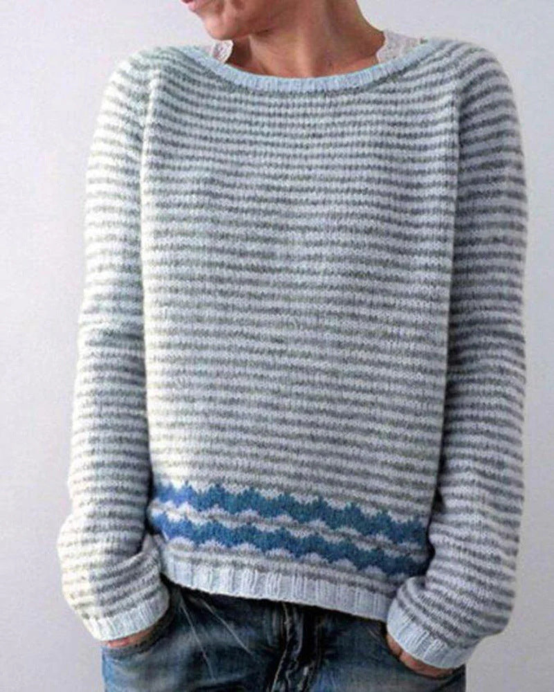 Pale blue and white striped jumper with a patterned band near the hem.
