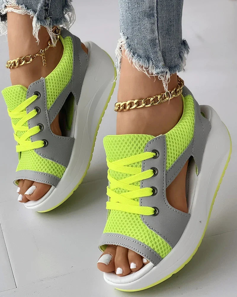 Bright-green lace-up sandals with open toes and side cut-outs.