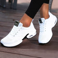 White lace-up trainers with textured uppers and curved contrasting soles.