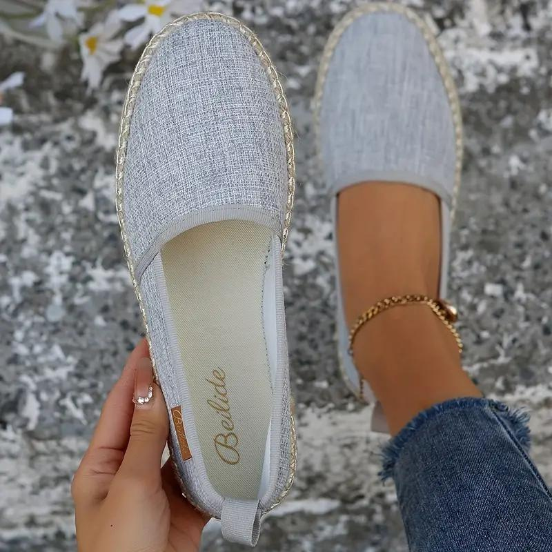 Grey espadrilles with rounded toes and canvas uppers.