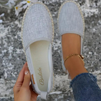 Grey espadrilles with rounded toes and canvas uppers.