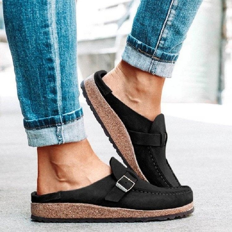 Black clogs viewed from the side with the open heel visible.