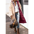 Reversed coat showing a cream teddy outer and wine-red inner.