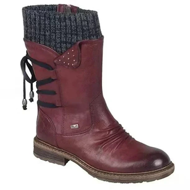 Red boot with a dark grey knit cuff, dark laces and a low heel.