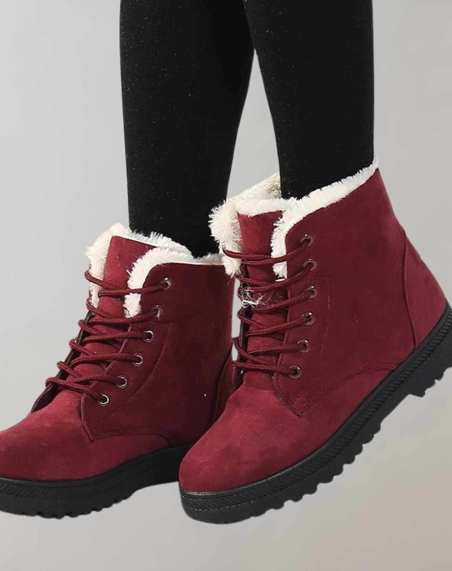Red ankle boots with laces and a dark sole.