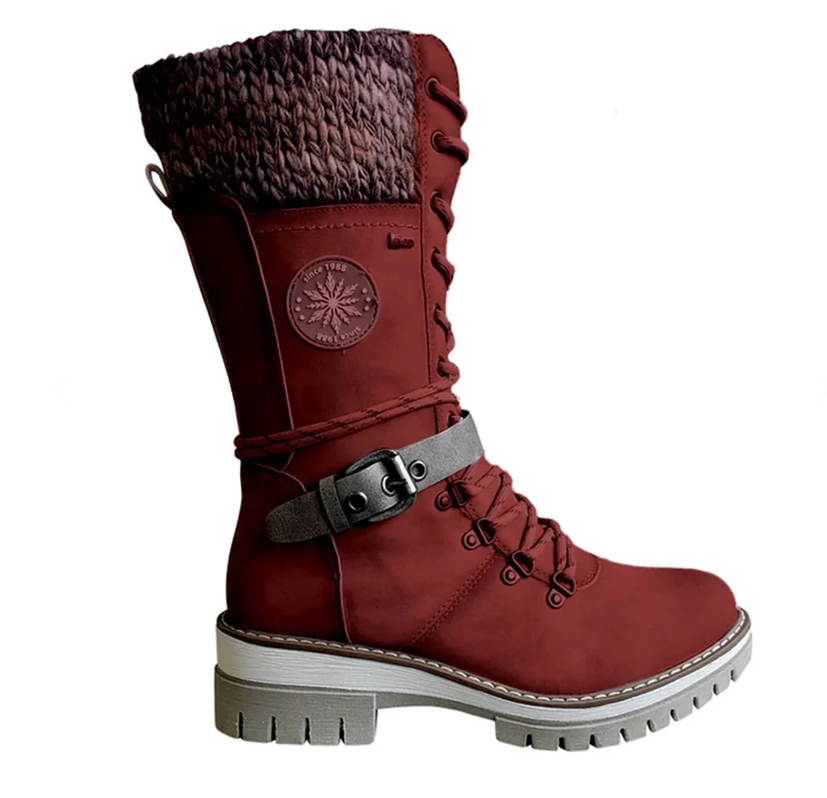 Red boot shown from the side with a dark buckle strap.