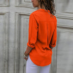 Red-orange blouse worn from the back.