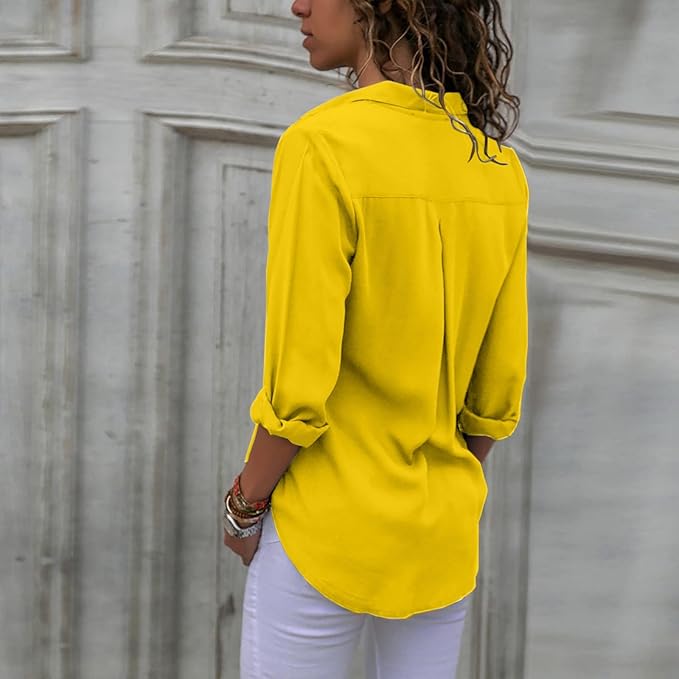 Yellow blouse worn from the back with a longer hem.