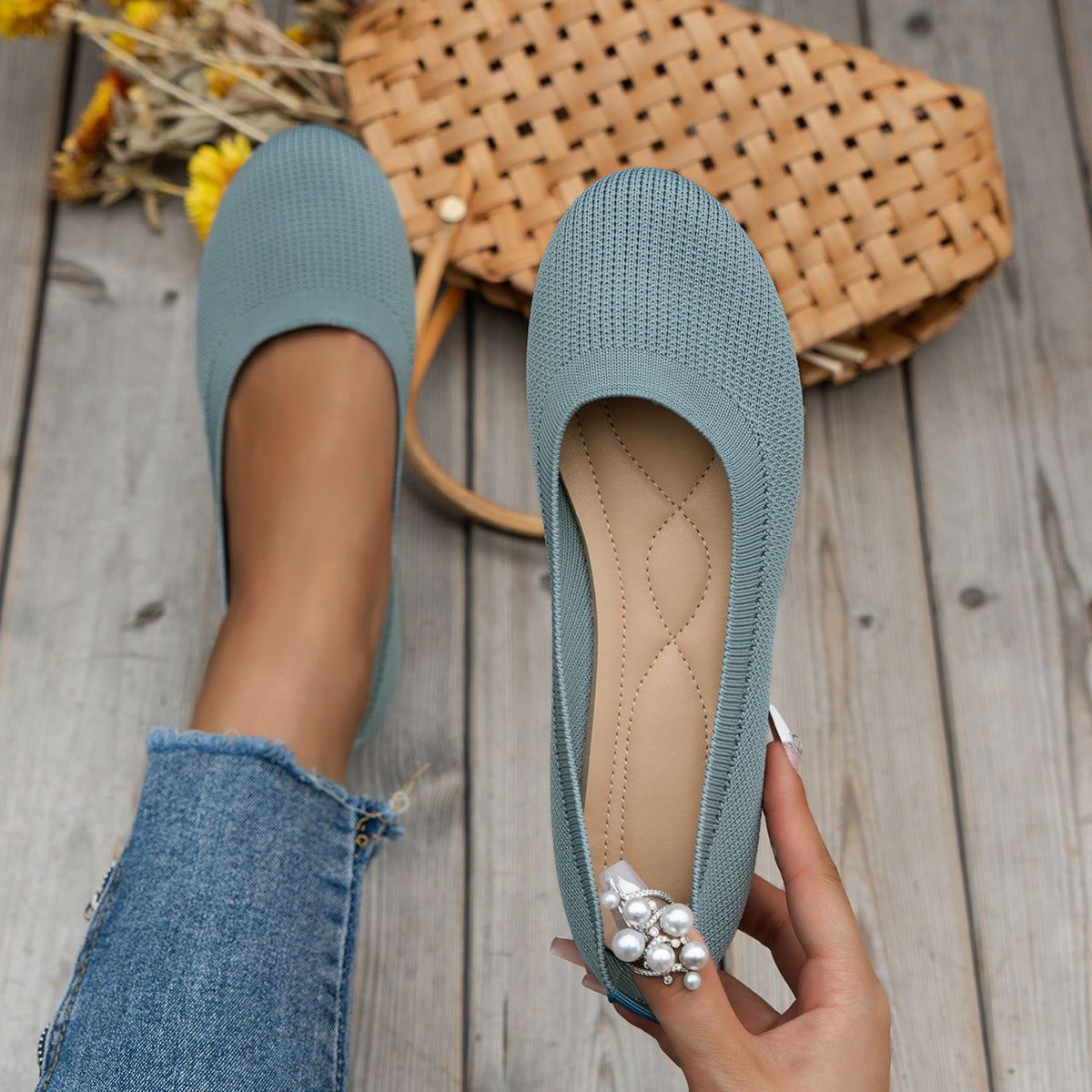 Light blue flats with rounded toes and low black soles.
