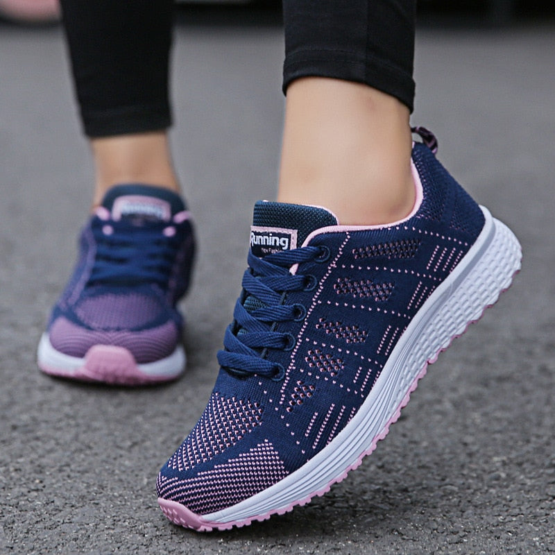 Blue trainers with pink accents and patterned mesh uppers.