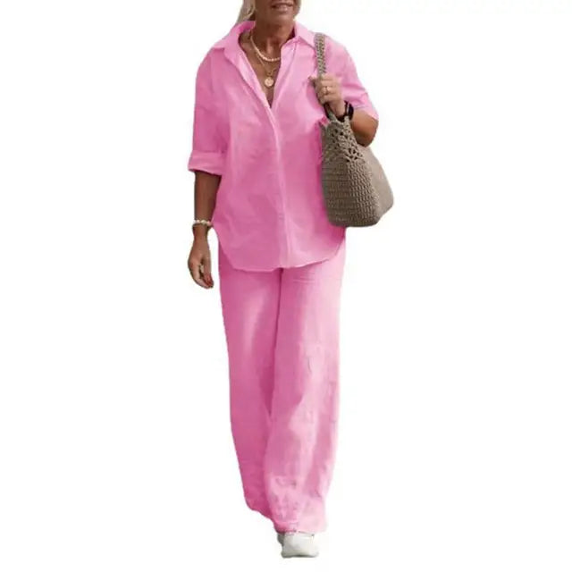 Pink two-piece set with a curved shirt hem and loose trousers.