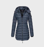 Blue long quilted coat with a hood and side pockets.