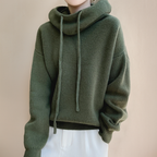 Green jumper with dropped shoulders and ribbed cuffs.