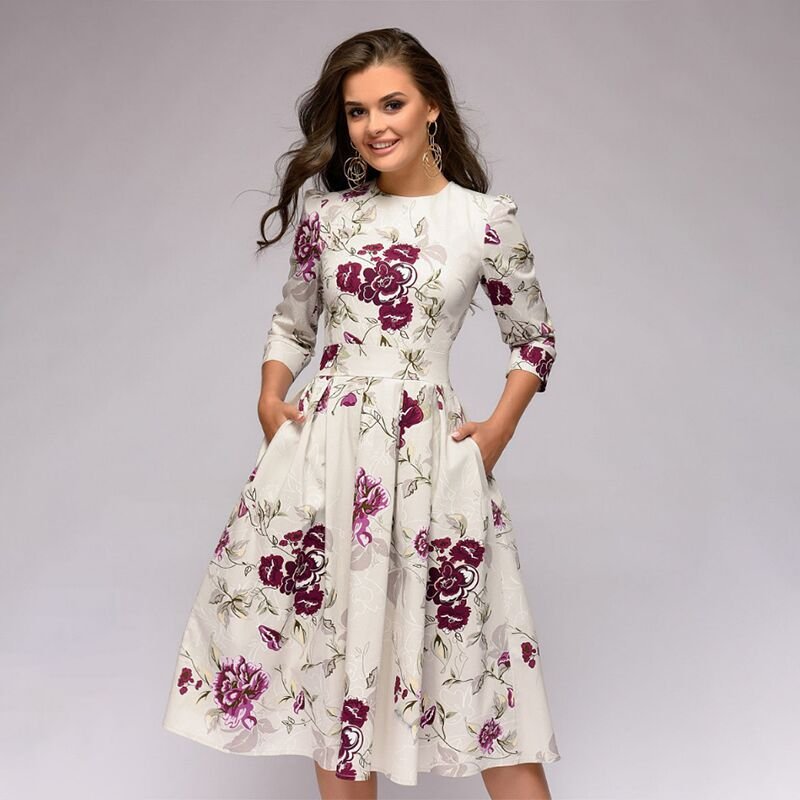 White Retrozo dress with large purple flowers and a full skirt.