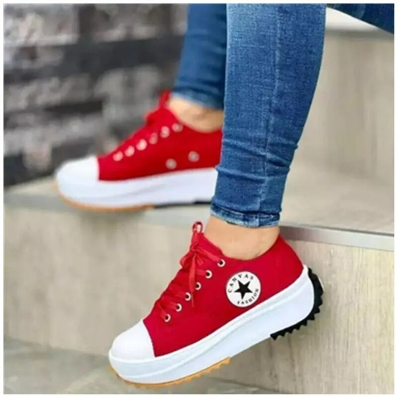 Red trainers with contrasting white toe caps and chunky soles.
