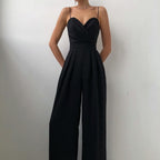 Black jumpsuit with slim straps, a folded bodice and wide legs.