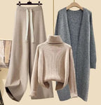 Beige roll-neck jumper and trousers displayed with a grey long jacket.