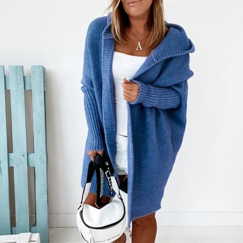 Blue cardigan worn open with a white top.