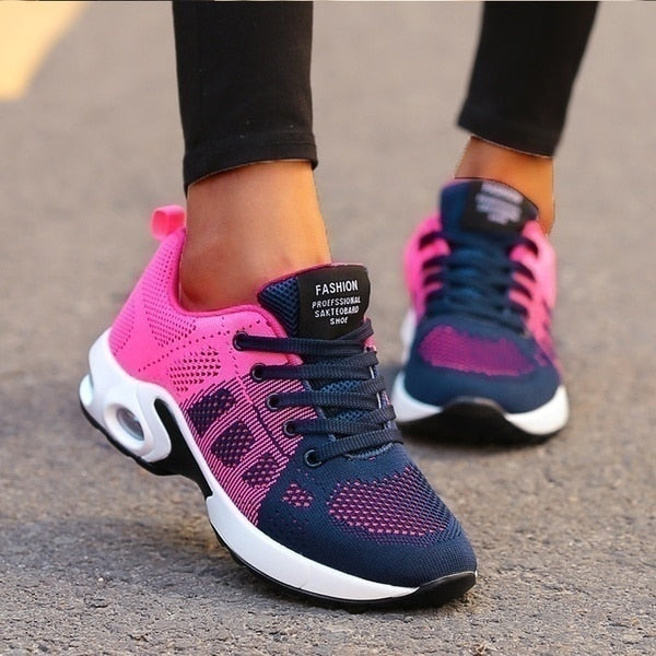 Pink and navy lace-up trainers with patterned uppers.