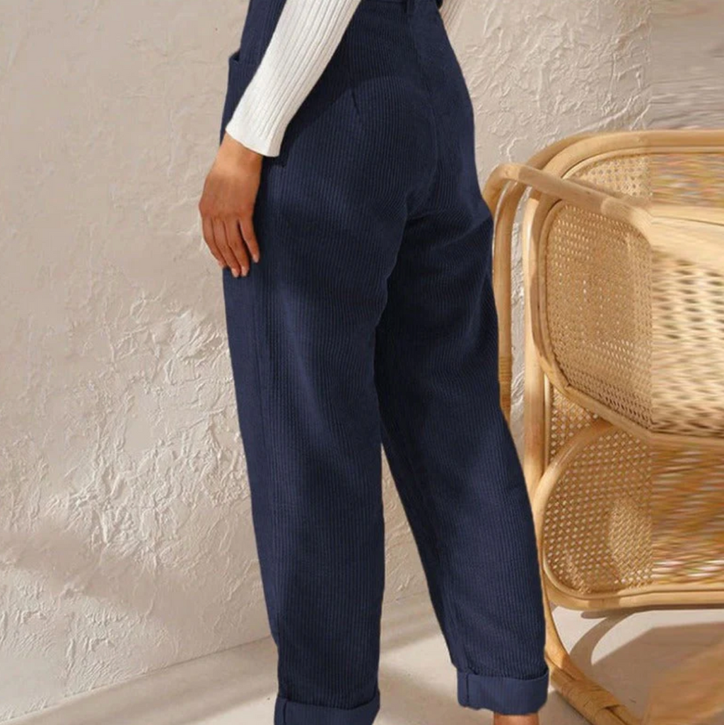 Rear view of blue trousers with tapered legs.