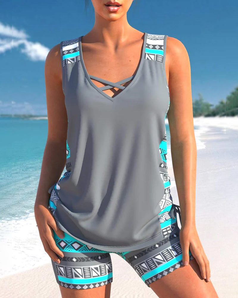 Grey tankini with crossed neckline straps, printed side panels and matching shorts.