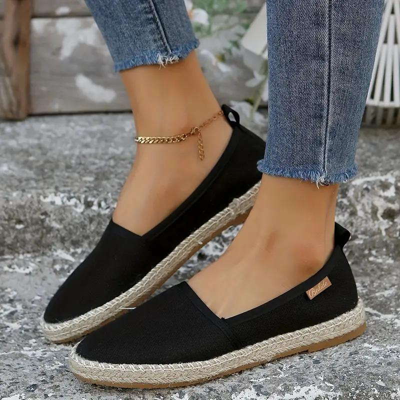 Black canvas espadrilles worn with cropped jeans.