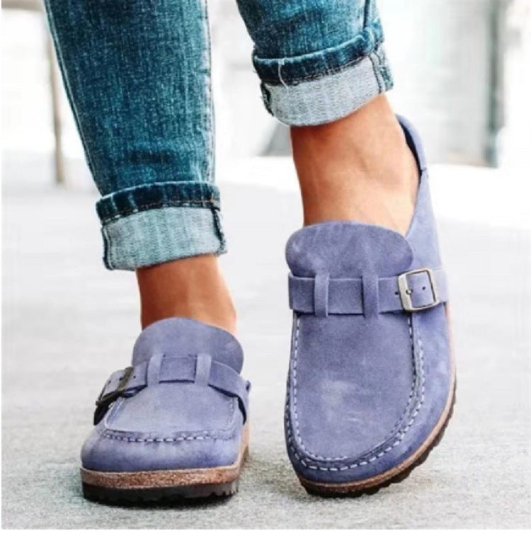 Purple-blue clogs with a cork-look layer above the dark outsole.