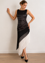 Black and white dress with gathered upper layers and an asymmetric hem, shown at an angle.