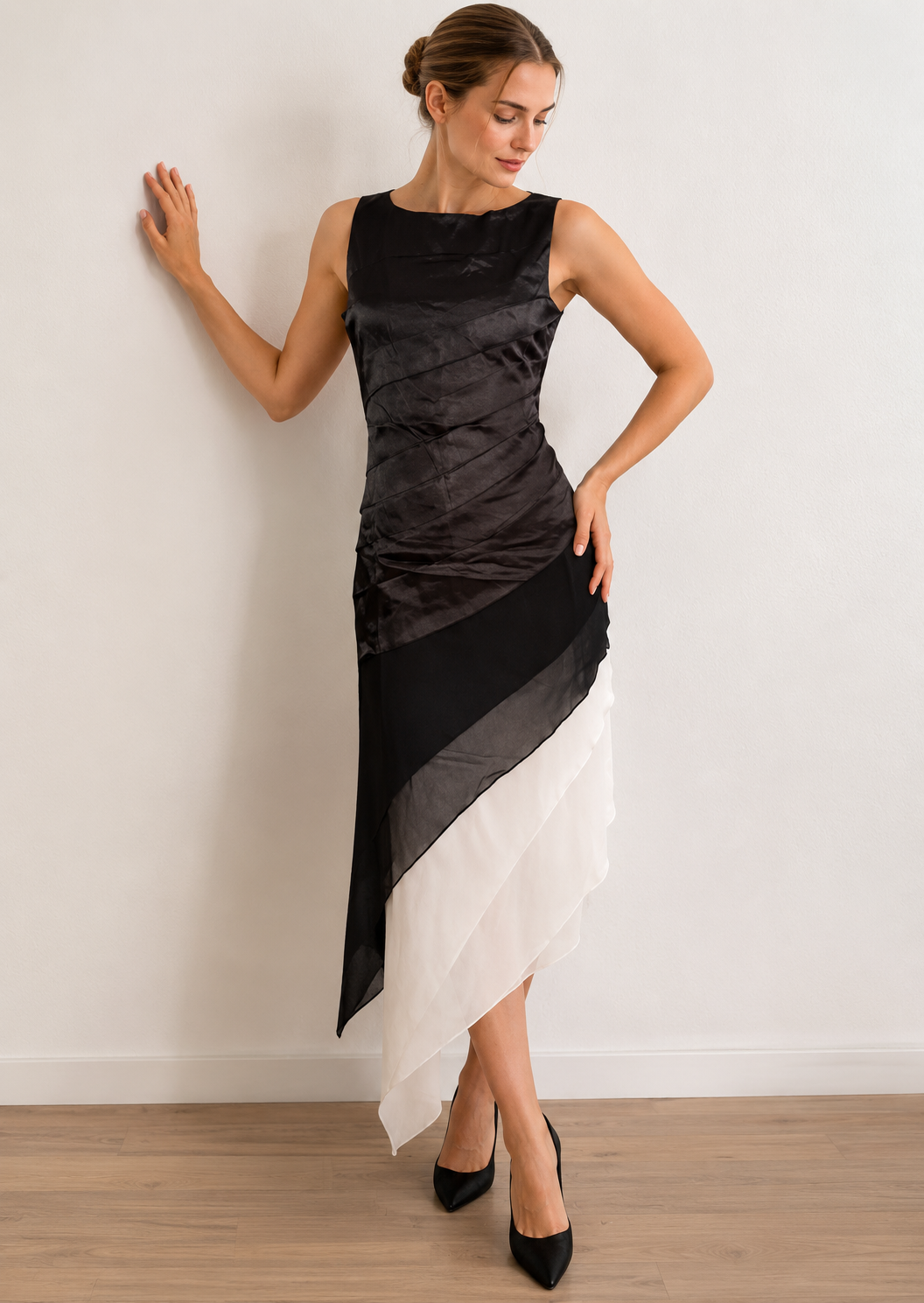 Black and white dress with gathered upper layers and an asymmetric hem, shown at an angle.