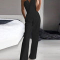 Black strapless jumpsuit with a folded lapel-style neckline and straight legs.
