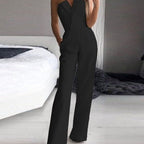 Black strapless jumpsuit with a folded lapel-style neckline and straight legs.