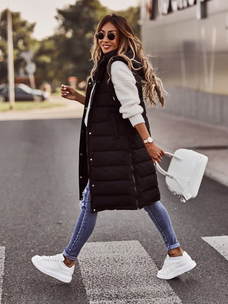 Black quilted gilet shown while walking.