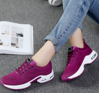 Purple mesh trainers with white curved sole panels.