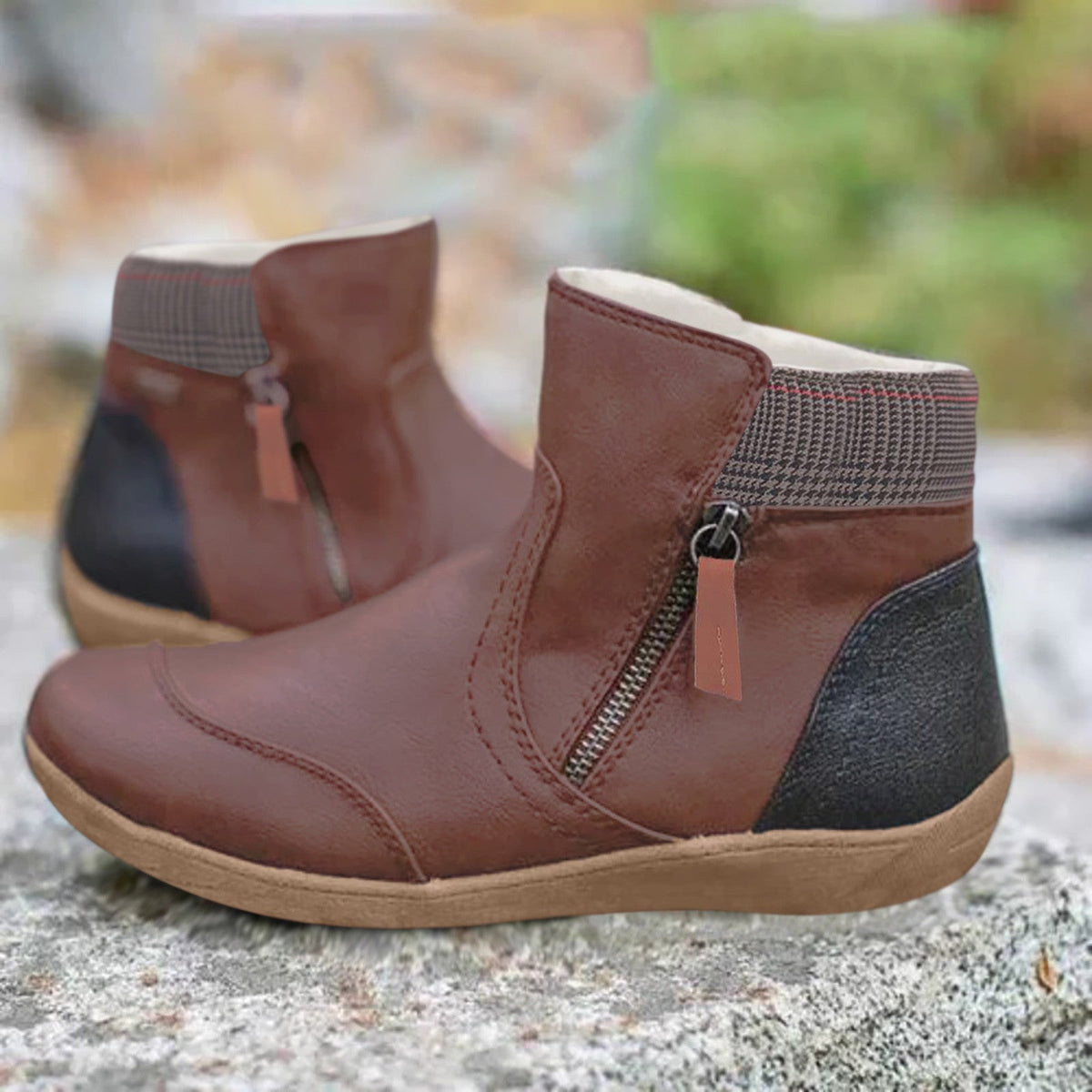 Brown ankle boots with dark heel panels and side zips with long pulls.